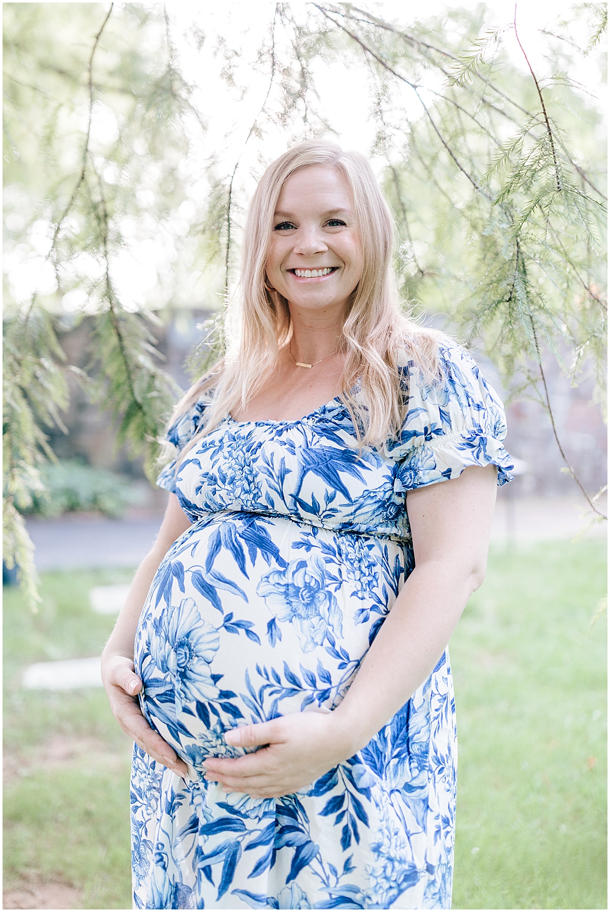 Longwood gardens maternity portraits with Katie for her baby boy. Katie is seen wearing a blue maternity dress surrounded by the greenery of the botanical gardens