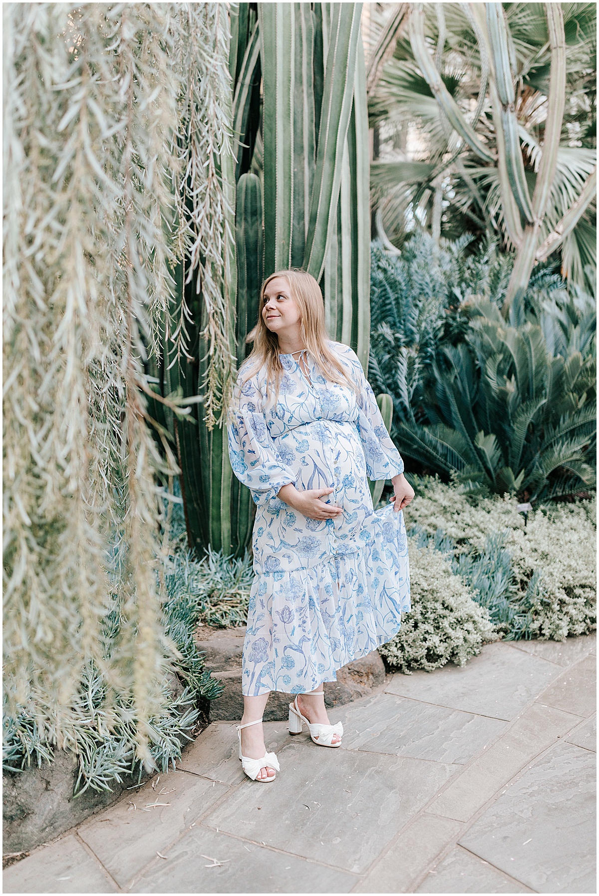 Longwood gardens maternity portraits with Katie for her baby boy. Katie is seen wearing a blue maternity dress surrounded by the greenery of the botanical gardens